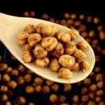 Air Fryer Chickpeas in wooden spoon held up over air fryer basket