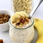 Banana Bread Overnight Oats in open glass jar with banana slices and chopped nuts on top