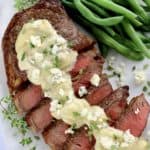 blue cheese sauce drizzle over sliced steak with green beans