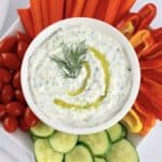 Tzatziki Sauce in white bowl with fresh veggies around