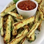 Baked Parmesan Zucchini Fries on white oval plate with side of marinara sauce