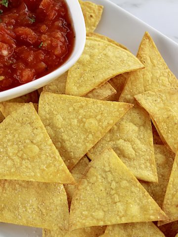 Easy Baked Tortilla Chips on white plate with salsa