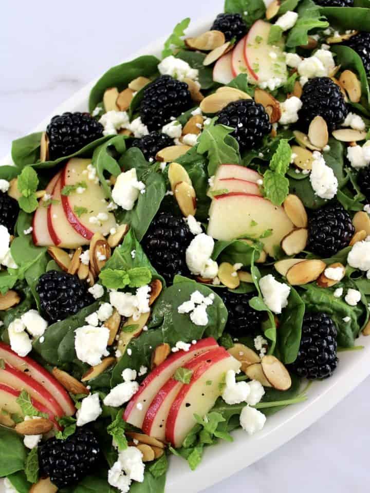 Spinach and Arugula Salad in white oval platter