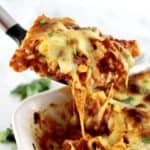 Baked Ziti being pulled out of casserole with cheese pulling