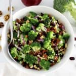 Broccoli Salad with Cranberries in white bowl with spoon