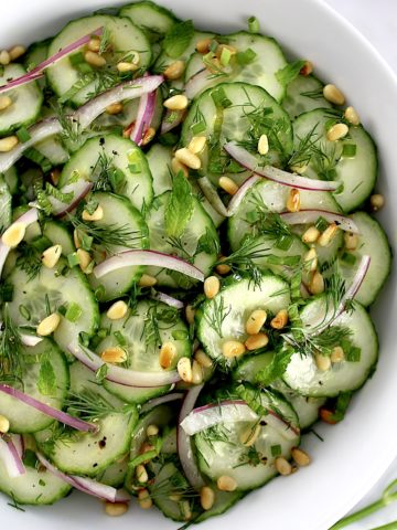 Cucumber Salad with red onion, fresh chopped herbs and toasted pine nuts