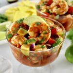 closeup of Mexican Shrimp Cocktail in mini trifle dish with lime slice on top