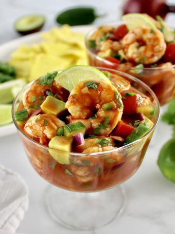 closeup of Mexican Shrimp Cocktail in mini trifle dish with lime slice on top