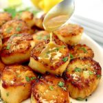 Seared Scallops with Garlic Butter being spooned over top