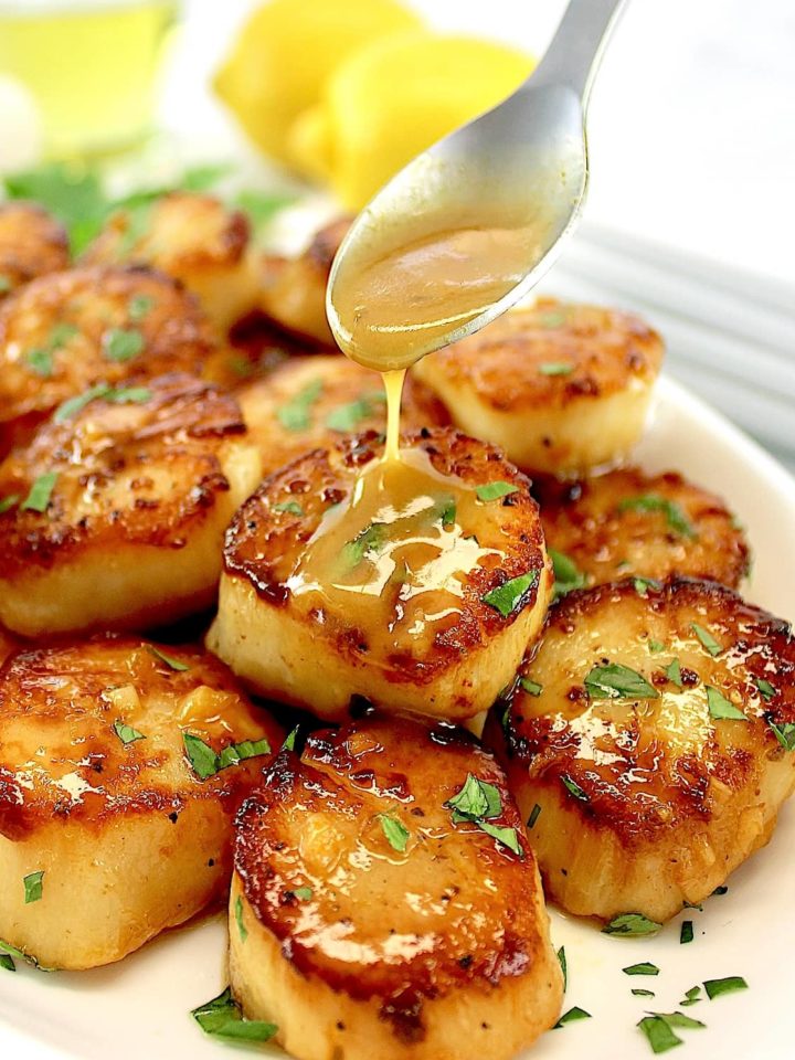 Seared Scallops with Garlic Butter being spooned over top